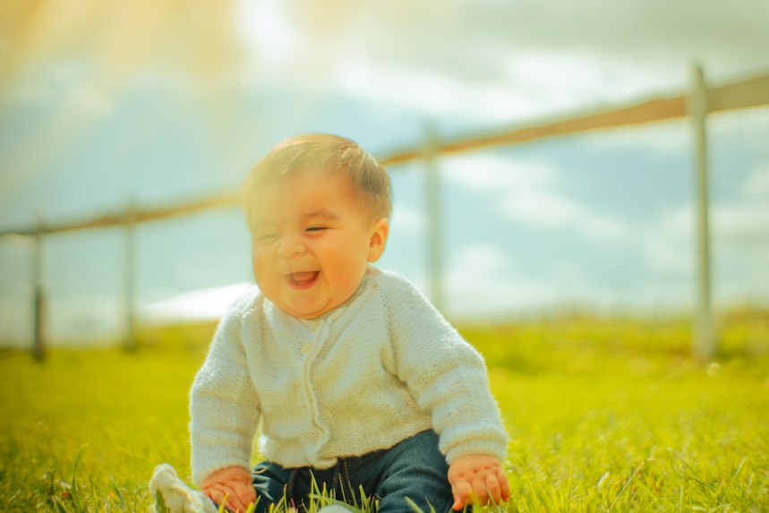 Child smiling next to a portable oxygen concentrator at home